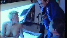 Blonde in a tanning booth gets a stick to eat and gets fucked inside